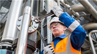 Employee maintaining plant Employee maintaining plant