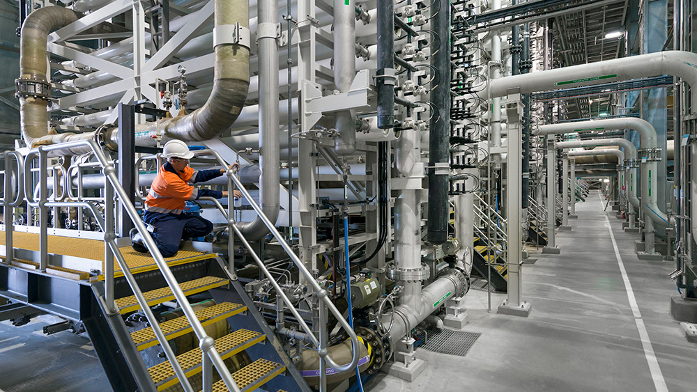 image of SUEZ employee testing water quality at Desal plant