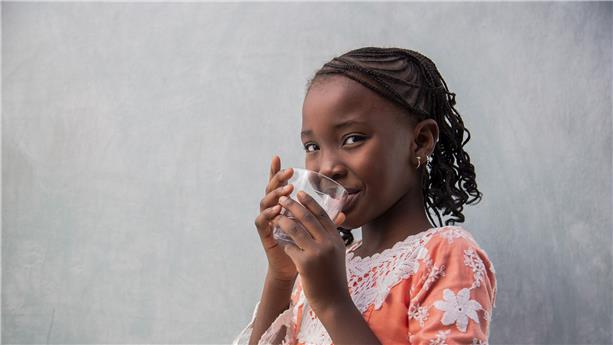 little girl with a glass