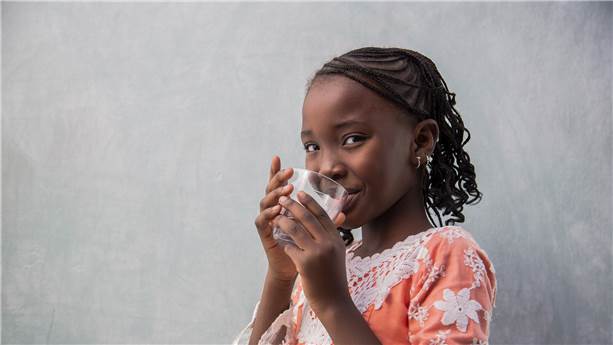 little girl with a glass