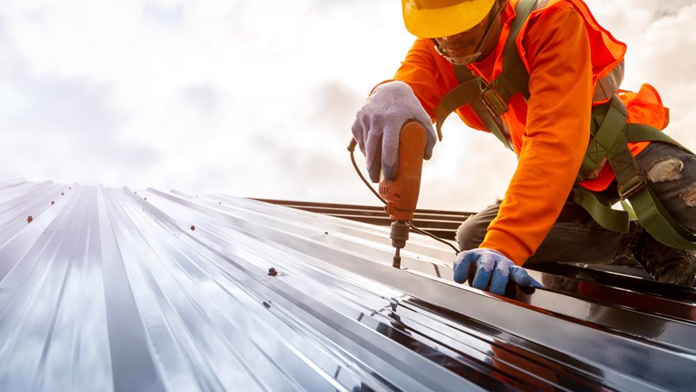 Construction worker installs new roof