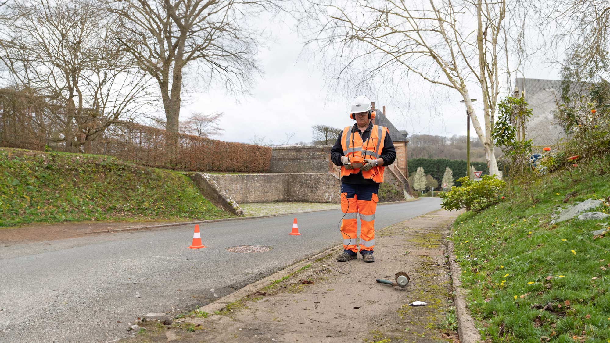 SUEZ employee searching for a water leak using a portable camera